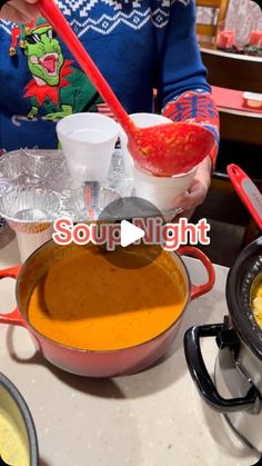 a woman is mixing food in a pot on the stove top with a red ladle