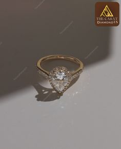 an engagement ring with a pear shaped diamond in the center