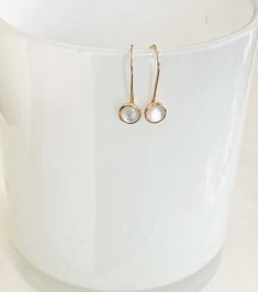 These simple, beautiful earrings are dainty but and versatile enough to be worn everyday.    They feature a 6mm white mother of pearl cabochon set in a 14kt gold filled bezel.  The ear wire is hand forged from 14kt gold filled wire.  The stone dangles about 1/2" below the earlobe. Delicate White 14k Gold Filled Earrings, Minimalist White Pearl Earrings In 14k Gold Filled, Minimalist White Pearl Earrings 14k Gold Filled, Dainty White Pearl Earrings In 14k Gold, Minimalist White 14k Gold Filled Pearl Earrings, Minimalist 14k White Gold Earrings, White Round Pearl Earrings In 14k Gold Filled, Minimalist White Pearl Earrings In 14k Gold, White 14k Gold Filled Pearl Earrings