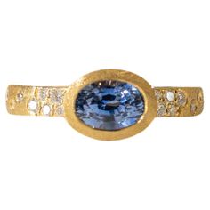 This exquisite piece showcases a captivating 1.23-carat oval sapphire, renowned for its deep blue hue and association with wisdom and royalty. Set in lustrous 18 karat yellow gold (18KY), the sapphire is securely held in a smooth bezel setting. The band, adorned with a delicate row of shimmering diamonds totaling 0.19 carats, adds a touch of sparkle and sophistication. Ring Size: 6.5 This ring is available in custom sizes. Please contact us with your preferred size for a price quote and estimated delivery time. Sapphire Bezel Ring, Oval Diamond Ring, Bezel Ring, Blue Sapphire Diamond, Price Quote, Geometric Diamond, Modern Ring, Green Sapphire, Pretty Wedding