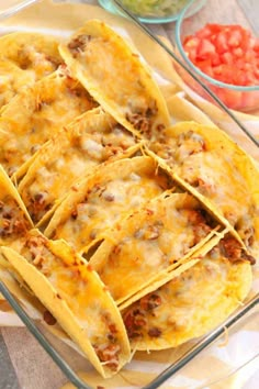 several tortilla shells with meat and cheese in a glass dish