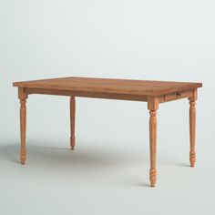 a small wooden table with two legs on an isolated white background in front of a plain wall