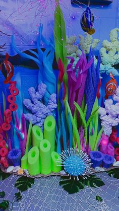 there are many different colored objects in the sea life display at this beachfront event