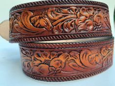 "How to find your size 2 ways to measure to order a belt. * You can measure inside the pant belt loops, like a belt. * Measure a belt from the end near the buckle ( do not include the buckle) to the hole you wear it in. This belt has a horse head and a brown or black floral, western scroll design embossed and antiqued. Sizes 20\" - 28\" are 1 1/4\" wide and have a single crease border. Sizes 30\" & up are 1 1/2\" wide and have a rope border. All belts are made of a solid leather strip of 100 Traditional Hand Tooled Brown Belt, Rustic Brown Hand Tooled Belt, Artisan Brown Embroidered Belt, Brown Embroidered Leather Belt, Nautical Belt, Belt Western, Double Buckle Belt, Rope Border, Horse Heads