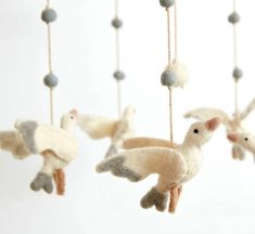 several small stuffed birds hanging from strings