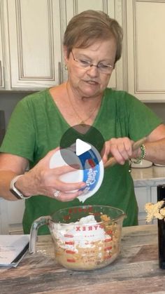 an older woman mixing food in a bowl