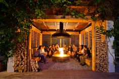 a group of people sitting around a fire pit