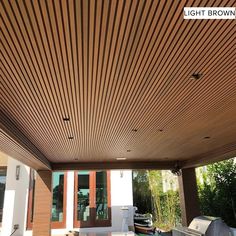 an outdoor covered patio with grills and chairs