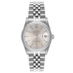 Ladies Midsize Rolex 31mm DateJust Stainless Steel Watch with Silver Dial and Fluted Bezel. Pre-Owned SN# L35**** Brand: Rolex. Gender: Ladies. Dial Color: Silver. Crystal: Sapphire. Bezel: Fluted Bezel. Condition: Very Good. Model Number: 68274. Case Dimensions: 31mm. Metal Type: Stainless Steel. Movement: Self-Winding (Automatic). Bracelet: Oyster Bracelet / Stainless Steel. Box / Certificate: Rolex Box / Certificate of Authenticity. Service Warranty: One (1) Year Limited Service Warranty. Elegant Silver Jewelry And Watches With Date Display, Silver Formal Watch Bands, Silver Watch Bands For Formal Occasions, Formal Silver Watch Bands, Classic Silver Jewelry And Watches With Date Display, Elegant White Gold Watch Bands With Date Display, Rolex 31mm Datejust, Zenith Watches, Rolex Watches Women