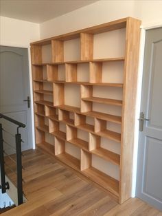 an empty bookshelf in the corner of a room