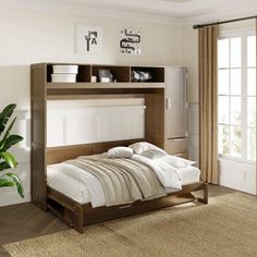 a bedroom with a bed, dresser and plant in it on the floor next to a window