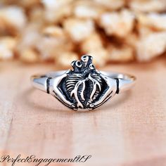 Anatomical Heart Hands Ring | Solid 925 Sterling Silver Gothic Style Ring | Womens Silver Ring | Halloween Theme Jewelry | Hands Heart Ring * Height: 10mm * Solid 925 Sterling Silver * Oxidized * Ring box included Processing and Shipping Details Ready to ship within 1-2 business days. USPS First Class mail is used for standard shipping. A tracking number is provided via email when the package is shipped. Faster shipping option is available.  Maintenance  Cleaning/Polishing - It is recommended to use a jewelry polishing cloth to clean silver jewelry.  It is also recommended to use jewelry cleaning solution every few months. Care - Proper maintenance is needed for color plated rings. Avoid contact with strong chemicals, household cleaning products, strong personal care products (lotion, perf Heart Promise Rings, Oxidized Ring, Cleaning Silver Jewelry, Jewelry Cleaning Solution, Anatomical Heart, Heart Hands, Hand Ring, Halloween Theme, Gothic Style