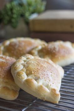 three pastries sitting on top of a cooling rack