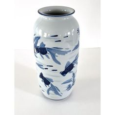 a blue and white vase with fish on it