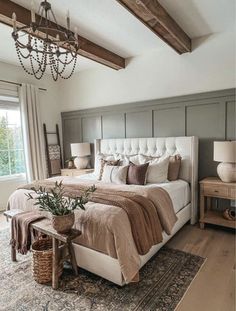 a bedroom with a large bed and chandelier in the ceiling, along with a rug on the floor