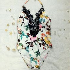 This Sexy, Gorgeous Halter Monokini Has A Deep Plunge Neckline & Is Decorated With Black Lace. It Has Golden Beads On The Neck Ties, Built In Padding & Is Double Layered. It Is White With Teal, Orange & Pink Floral Pattern. The Panty Line Is Cheeky At The Butt. Length For Extra Small: 20.5" Length For Small: 22" 20% Off Your Entire Purchase When You Bundle With Any Other Item(S)! White One-piece Tankini For Spring, Chic Party Swimwear With Floral Print, Chic Floral Print Party Swimwear, White V-neck Tankini For Summer, Summer One-piece Intimate For Party, White V-neck Summer Tankini, Summer Party One-piece Intimate, White Backless Tankini For Summer, Summer White Backless Tankini