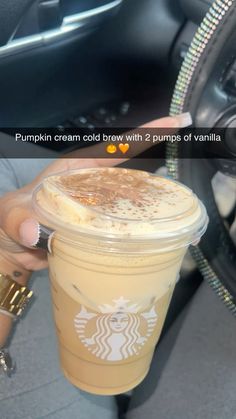 someone holding up a cup of coffee with whipped cream in it and the caption pumpkin cream cold brew with 2 pumps of vanilla