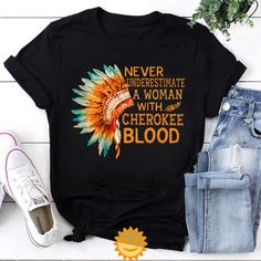 Product details: ✔️ NAME: Never Underestimate A Woman With Cherokee Blood Vintage T-Shirt, Native American Shirt, Native Land Shirt, Indigenous Shirt ✔️ IMPORTANT NOTE: Both Men and Women can we our shirts because this is unisex style t-shirts;  Wash item inside out in cold water, do not bleach, do not dry clean, do not iron directly on the design. ✔️ MATERIAL: 5.3-ounce, 100% cotton (99/1 cotton/poly (Ash) & 90/10 cotton/poly (Sport Grey); Heavyweight classic unisex tee; Taped neck and shoulders; Tearaway label; Decoration type: Digital Print ✔️ OUR DESIGN PRODUCTS: Each One are designed and sold in limited quantities. The designs are created by our incredibly talented in house graphic art team who often hand draw and illustrate each Tee shirt design. ✔️ SIZE CHART: Please refer the attac Native American Inspired Fashion, Native American Shirt, Native American Shirts, Never Underestimate A Woman, Tee Shirt Designs, Never Underestimate, American Shirts, Unisex Style, Vintage Tshirts