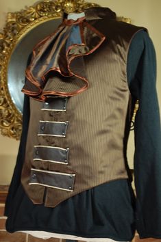 "This is a gentleman's waistcoat with a corseted back to give shape. Made in brown satin pinstripe. This listing is for the waistcoat only. The Jabot (round the neck) has it's own listing. Fully lined. metal and plastic boning. Fasteners are poppers. Measurements; Size Chest  Waist Nape to waist at the back  ( waistcoats are a few inches longer at the front than the back) *PLEASE NOTE*  You want the waistcoat to be about 2 \" too small so that it can act as a corset and give shaping at the back.  Waist measurements should be taken around the widest part of your tummy, not where you wear your trousers if that is lower, so don't use the measurement you use to buy trousers! Please fell free to ask for advice on fit. Pockets; no Collar; Yes" Walking Skirt, Brown Pinstripe, Sweet T, Brown Satin, Mens Vests, Vest Outfits, Black Ribbon, Hand Warmers, Cosplay Costumes