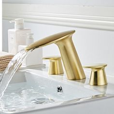 a faucet with water running from it and soap dispenser nearby