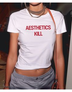 ⚡️Aesthetics Kill - Brat Style Tee⚡️ 💚 The "Aesthetics Kill" baby tee makes a bold statement with it's minimalist design, and bold text. Classic 90s style statement tee  Ironic statement tee, classic 90's -  2000's unisex 'baby tee', relaxed fit, brat style  💅 Designed by Emotional Trance. 🌿 This tee is made with 100% cotton, ethically grown & harvested in the USA ✊ We are members of the US Cotton Trust Protocol ensuring ethical and sustainable means of production 🕯️ Baby Tee Origin Story Ou Y2k Summer T-shirt With Graphic Design, Y2k Graphic Design T-shirt For Summer, White Cotton Aesthetic T-shirt, Y2k Style Graphic T-shirt For Spring, Fitted Grunge Tops With Graphic Design, Spring Y2k T-shirt With Graphic Design, Spring Y2k Style Graphic T-shirt, Spring Y2k Graphic T-shirt, Spring Y2k Graphic Design T-shirt