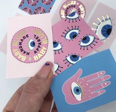 someone holding up some cards with eyeballs on them