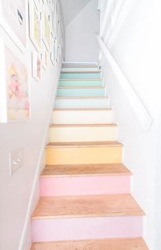 the stairs are painted in different shades of pink, yellow and blue