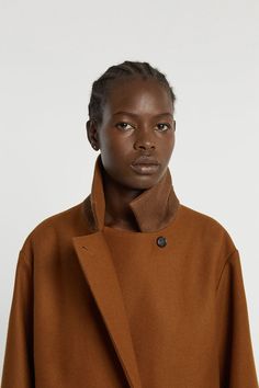 This coat is made from a wool and cashmere fabric woven in Italy near lake Lugano. The structured and slightly oversized cut was designed with precision. Details include raglan pockets, a concealed button packet with corozo buttons and a back vent. The inside of the coat is lined in viscose and the concealed part of the collar is made of mottled wool felt. WHY WE LOVE IT INDRESS was founded in Paris in 2001 by Dutch designer Wies Schulte with the desire to combine elegance, timeless shapes and v Oversized Brown Wool Coat For Work, Fall Cashmere Wool Coat With Concealed Placket, Structured Wool Coat With Concealed Placket For Fall, Structured Brown Outerwear For Fall, Oversized Brown Wool Coat, Oversized Brown Wool Outerwear, Brown Cashmere Outerwear With Button Closure, Lake Lugano, Derek Rose