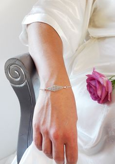 The Bridal Bracelet Gabrielle is composed of a silvery chain and the center of the bracelet is a diamond-shaped divider, hand weaved with galvanised silvery rocaille beads.   The beads used have a "DURACOAT" finish, which means that the metallic colour of the beads will last in time thanks to a process of galvanization.  It will perfectly match the bridal Headband GABRIELLE available in the shop.  This bracelet is 16 cm long with 2 extra rings to adjust the size to your wrist.  -----YOU WILL ALSO LIKE ----- *BRIDAL HEADBAND GABRIELLE*  https://www.etsy.com/fr/listing/779031972/headbandcouronne-mariee-fines-perles?ga_search_query=gabrielle&ref=shop_items_search_2&frs=1 Current creation timeframe: 10 days  ---- For any other personalization/changes please do not hesitate to contact me at con Silver Crystal Bracelet With Diamond Cut, Silver Diamond-cut Crystal Bracelets, Silver Crystal Bracelets With Diamond Cut, Adjustable Diamond White Sterling Silver Bracelet Gift, Wedding Silver Cubic Zirconia Charm Bracelet, Silver Cubic Zirconia Charm Bracelet For Wedding, Silver Diamond-shaped Jewelry, Delicate Silver Chain Bracelet For Party, Crystal Bracelets With Diamond Cut For Gift