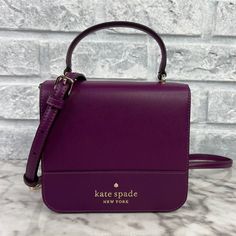 Brand New With The Tag Authentic Color Is Plum Pie Gold Hardware Saffiano Leather Metal Pinmount Logo Two Way Spade Jacquard Lining Interior: Back Credit Card Slots Exterior: Back Slip Pocket Flap With Magnetic Snap Closure 5.92"H X 6.48'w X 2.16"D Handle Drop: 3.25" Strap Drop: 22" Same Or Next Day Shipping! Elegant Purple Bag With Top Carry Handle, Chic Purple Handheld Satchel, Purple Square Shopping Bag, Classic Purple Evening Bag, Classic Purple Shoulder Bag With Detachable Handle, Purple Top Handle Box Bag For Travel, Purple Top Handle Box Bag For Daily Use, Purple Top Handle Bag With Detachable Handle, Purple Rectangular Bag With Dust Bag