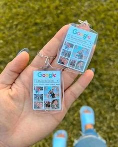 someone is holding two keychains in their hand with pictures attached to the tags