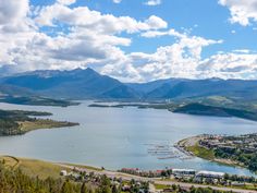 an aerial view of a lake surrounded by mountains