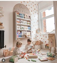 two children playing with toys in a room