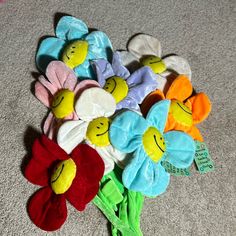 a bunch of stuffed flowers sitting on the floor