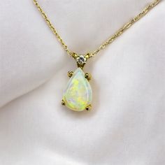 SAME DAY SHIPPING! This is a gorgeous solid 14k Yellow Gold necklace with a mesmerizing pear cut natural opal gemstone in an pear cut cabochon with round cut diamond accent. The solid 14k yellow gold chain is approximately 18 inches long, pendant approximately 12.5mmx6mm. Excellent anniversary gift for wife, girlfriend, october birthstone birthday gift for daughter, etc.!  Mothers Day Gift or Christmas Gift! We also sell 10k, 18k, and 14k jewelry, engagement rings, wedding rings, promise rings, Teardrop Gemstone Accent Necklace For Anniversary, Yellow Gold Pear-shaped Gemstone Drop Necklace, Pear-shaped Gemstone Drop Necklace In Yellow Gold, Teardrop Opal Gemstone Necklaces, Teardrop Opal Necklace With Gemstone, Opal Teardrop Gemstone Necklace, Pear-shaped Jewelry With Gemstone Accents, Yellow Gold Opal Teardrop Pendant Necklace, Fine Jewelry Pear Shaped Birthstone Necklace