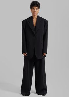 Color: Black Midweight suiting fabric Oversized fit Notch lapels Padded shoulders Front flap pockets Front button closure Lined 81% Polyester 15% Rayon 4% Elastane Dry Clean By The Frankie Shop. Imported Single Breasted Structured Pantsuit For Business, Single-breasted Structured Pantsuit For Business, Structured Single Breasted Pantsuit For Business, Classic Single Breasted Pantsuit For Work, Classic Single-breasted Pantsuit For Work, Classic Black Pantsuit With Pockets, Black Oversized Blazer For Formal Occasions, Business Pantsuit With Lapel Collar, Business Pantsuit With Notch Lapel And Pockets