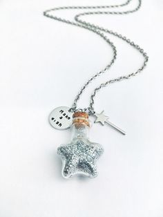 This stainless steel necklace would make a wonderful gift of luck to anyone looking for a little magic. It is hand stamped by me and it features: - a glass bottle (23x21mm) full of silver glitter - a wand charm (20mm long) - an aluminum circle tag (16mm) Personalization: - Choose from the drop down option the length of the necklace and the color of the glitters inside the bottle. IMPORTANT: the cork has been securely glued in place but the bottle is made of glass so it can breakplease handle wit Magical Silver Charm Necklaces For Gift, Magical Silver Charm Necklaces As Gift, Handmade Silver Charm Necklace For Best Friend, Whimsical Star Charm Jewelry As Gift, Whimsical Star Charm Jewelry Gift, Star-shaped Stainless Steel Necklace For Gift, Stainless Steel Necklaces With Star Charm For Gifts, Stainless Steel Necklace With Star Charm For Gift, Stainless Steel Necklace With Star Charm As Gift