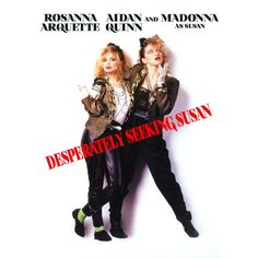 two women standing next to each other in front of a white wall with the words desperately seeking susan on it