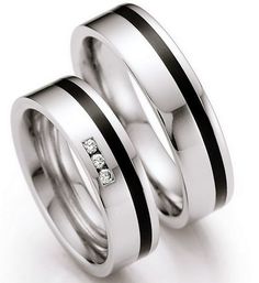 two white gold wedding rings with black and white diamonds