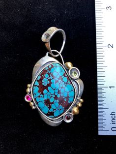 "Prince Turquoise gemstone pendant Hand-made Sterling Silver 925, 24k Gold Stones used: Prince Turquoise, Garnet, Peridot, Cubic Zirconia Height - 2 1/2\" (with bail), Width - 1 3/8\" Height -60mm (with bail), Width - 35mm Unique Handcrafted One-of a-kind Design Pendant Each Piece of Jewelry in my Collection is Absolutely One of a Kind! When you start wearing a piece of my jewelry you will fall in love with it more and more each day and feel that good Energy and Love that I pass into it while cr Gold Turquoise Pendant Necklace In Sterling Silver, Artisan Sterling Silver Square Pendant Jewelry, Artisan Turquoise Jewelry For Anniversary, Artisan Pendant Jewelry With Natural Stones, Traditional Turquoise Necklace With Large Pendant As Gift, Traditional Turquoise Necklace With Large Pendant, Unique Turquoise Jewelry For Anniversary, Unique Sterling Silver Square Pendant Jewelry, Artisan Turquoise Jewelry As Gift