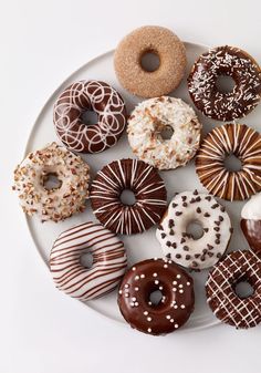 a white plate topped with lots of donuts