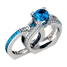 two wedding rings with blue and white diamonds on top of each other, set in 18k white gold