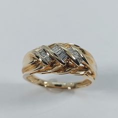 a gold ring with two diamonds on it