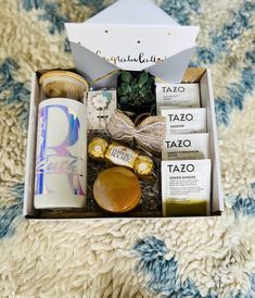 an open box with various items inside on a rug