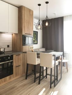 a kitchen with wooden floors and white cabinets