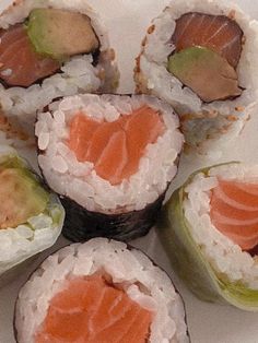 sushi rolls are arranged on a white plate