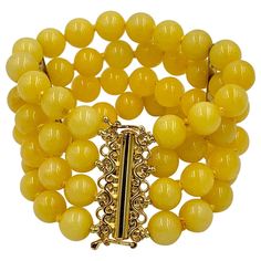 A stunning Yellow Chalcedony Bead Four Strand Bracelet with 9mm wide Chalcedony beads. The dramatic statement bracelet with the Chalcedony beads in vivid yellow is just fabulous. The bracelet is 6 inches long and 1 3/8 inches wide. It has a wonderful barrel clasp with safety catches which is Sterling Silver with a Gold wash. From the estate jewelry of one of New York's favorite socialites who adored her vividly colored jewels! The retro bracelet is a delight for everyday or for the most glamorou 1970s Jewelry, Chalcedony Bracelet, Arts And Crafts Style, Chalcedony Necklace, Retro Yellow, Retro Bracelet, Bracelets Beaded, Modern Bracelets, Chalcedony Stone