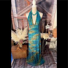 Beautiful Mermaid Halter Maxi Dress With Animal Print Is A Real Head Turner. The Turquoise And Green Colors Are So Lovely And Vibrant. This Dress Has A Back Zipper And Fits Snugly Through The Waist And Hips And Then It Flows Beautifully When You Walk. The Measurements Are Armpit To Armpit: 15" And From The Top Of The Zipper In The Back, The Length Is 50" Long. The Style On The Tags Say It Is Lynnea. This Dress Has Never Been Worn, Only Tried On And Has Not Been Hemmed. It Will Be Beautiful On Yo Fitted Bohemian Maxi Dress For Evening, Bohemian Fitted Maxi Dress For Cocktail, Fitted Bohemian Maxi Dress For Cocktail, Blue Bohemian Maxi Dress For Evening, Halter Maxi Dress, Beautiful Mermaids, Halter Maxi, Halter Maxi Dresses, Bcbgmaxazria Dresses