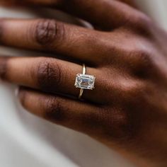 a woman's hand with a diamond ring on it