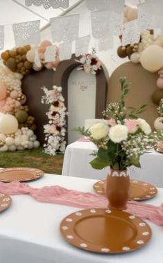 a table with plates and flowers on it